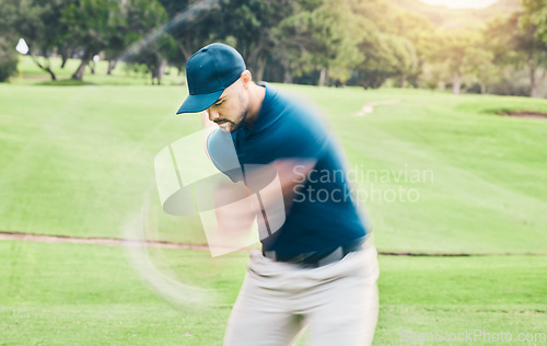 Image of Golf, motion blur and hobby with a sports man swinging a club on a field or course for recreation and fun. Golfing, grass and training with a male golfer playing a game on a green during summer