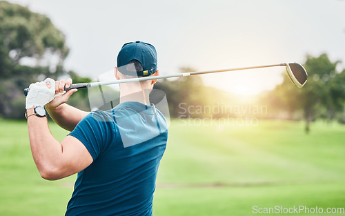 Image of Golf, stroke and back with a sports man swinging a club on a field or course for recreation and fun. Golfing, grass and training with a male golfer playing a game on a green during summer