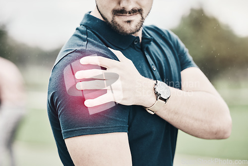 Image of Sports, shoulder pain and man on golf course holding arm during game massage and relief in health and wellness. Green, zoom on hands on muscle for support and golfer with ache during golfing workout.