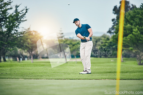 Image of Golf, stroke and aim with a sports man swinging a club on a field or course for recreation, fun and hobby. Golfing, grass and training with a male golfer playing a game on a green during summer