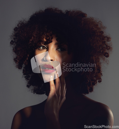 Image of Shadow, red lipstick and makeup on woman with beauty or natural hair in studio. Face of aesthetic female model with a skin glow, shine and color on lips for art, power and facial skincare