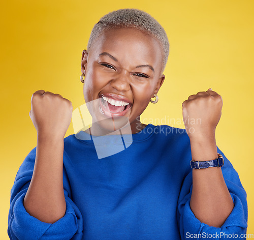 Image of Portrait, happy black woman and fist of winner in studio for celebration, achievement deal and success. Excited female model celebrate winning prize on background for lottery, bonus victory and smile