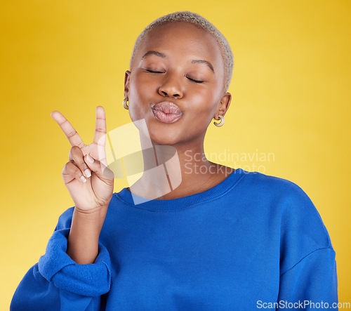 Image of Happy, success and black woman with peace sign, support and cheerful against a studio background. African American female, lady and v hand gesture with smile, happiness and facial expression with joy