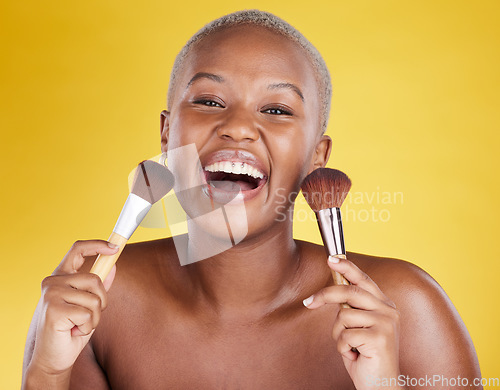 Image of Face, laughing and black woman with makeup brush in portrait in studio isolated on a yellow background. Cosmetics, beauty and happy female model with tool to apply foundation or powder for skincare.