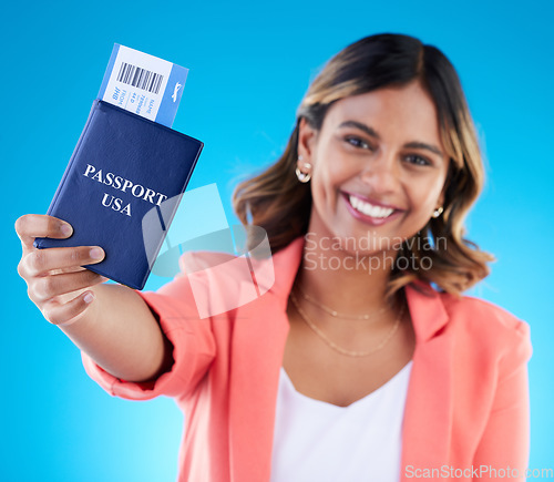 Image of Happy woman face show passport isolated on blue background for USA travel opportunity, immigration or holiday. Identity document, flight ticket and excited portrait of young indian person in studio