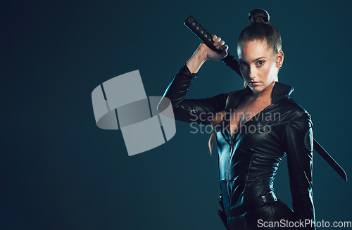 Image of Woman, warrior and portrait with space in studio for action, fight and safety from danger on dark background. Strong female model or assassin in scifi leather cosplay costume and sword for action