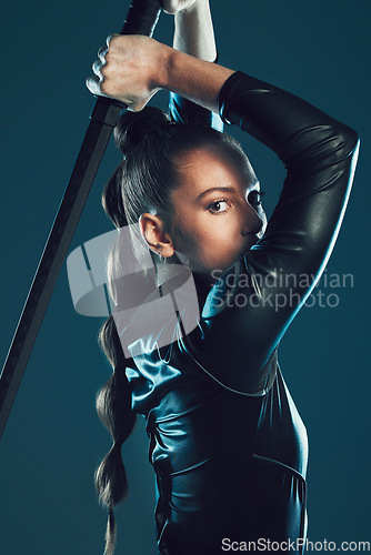 Image of Woman, warrior and vigilante in cosplay with sword ready for battle, war or game against a dark studio background. Portrait of female in black hero costume with blade for halloween or superhero