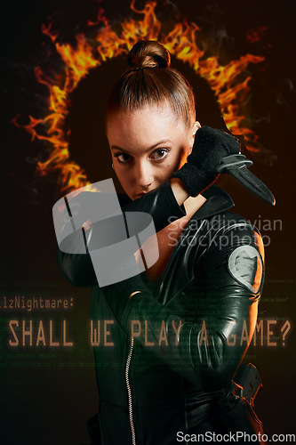 Image of Woman, warrior and vigilante in cosplay with dagger ready for battle, war or game against a dark studio background. Portrait of serious female in black superhero costume with knife for halloween