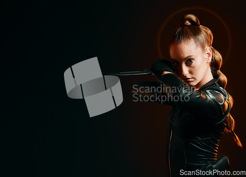 Image of Woman, warrior and knife in studio with space for action, fight and safety from danger. Strong female model, assassin or agent in scifi leather cosplay costume with weapon on a dark mockup background