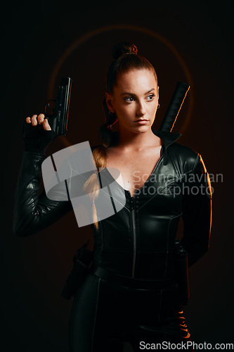 Image of Serious woman, warrior and gun in studio for action, fight and safety from danger on dark background. Strong female assassin or agent in scifi leather cosplay costume with weapon to fight or guard