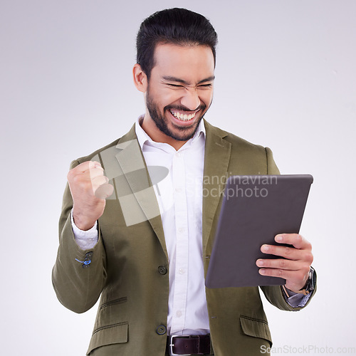 Image of Success winner man on tablet isolated on studio background fist pump for stock market, trading or business news. Winning profit of asian person on digital tech celebration, bonus or sales achievement