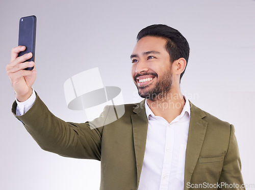 Image of Businessman, face and selfie with smile for profile picture, vlog or social media against a white studio background. Happy isolated employee man smiling on smartphone for photo, memory or online post