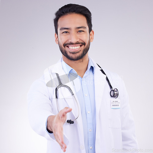 Image of Doctor, man and handshake for healthcare partnership, meeting or greeting against a white studio background. Portrait of happy male medical professional shaking hands for introduction or thank you