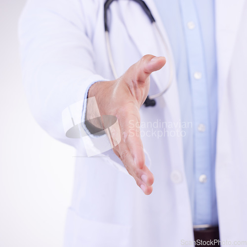 Image of Doctor, man and handshake for healthcare partnership, meeting or greeting against a white studio background. Hand of isolated male medical professional shaking hands for introduction or thank you