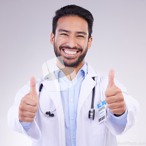 Image of Thumbs up portrait of man doctor isolated on a white background in healthcare success, thank you and service support. Like, yes and ok hands sign with face of medical worker or asian person in studio