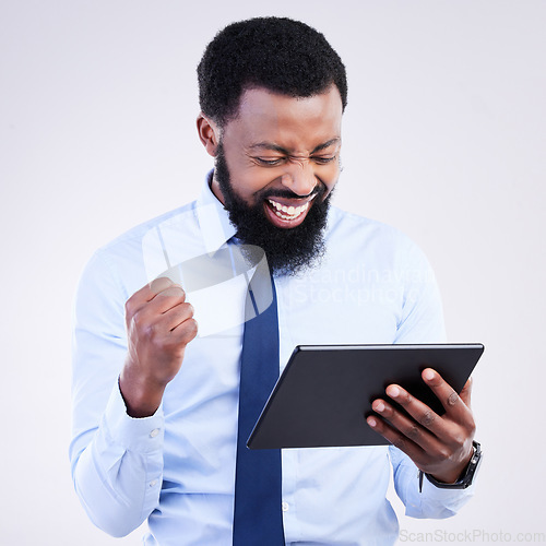 Image of Winning, tablet and black man isolated on gray background stock market, trading or business bonus, news and success fist pump. Happy person or winner sales, profit or goals on digital tech in studio