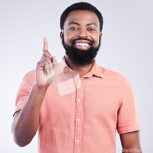 Image of Black man, studio portrait and point finger for answer, question and smile with confidence by background. Young model, african student and hand gesture with happiness on face for fashion by backdrop