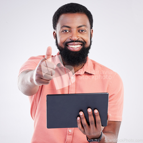 Image of Thumbs up portrait, tablet or happy black man with emoji gesture for congratulations, job well done or winner. Agreement, finance results or studio person with yes sign for success on grey background