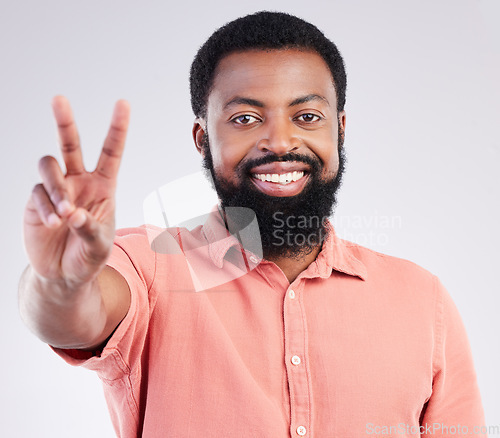 Image of Black man, hand and peace sign in studio portrait with smile, emoji or happiness by background. Young african model, signal or zen symbol for opinion, mindset or voice for confident pride by backdrop