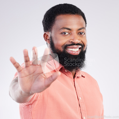 Image of Black man, hand and stop in studio portrait with smile, sign language and communication by background. Young african model, signal or symbol for opinion, protest palm and voice with confident pride