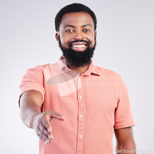 Image of Portrait, success and black man with handshake, greeting and happiness against studio background. Face, African American male employee and entrepreneur with gesture for welcome, smile and trust