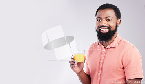 Image of Orange juice, studio portrait and happy black man with drink glass for hydration, liquid detox or weight loss beverage. Vitamin C benefits, male nutritionist diet or person on mockup gray background