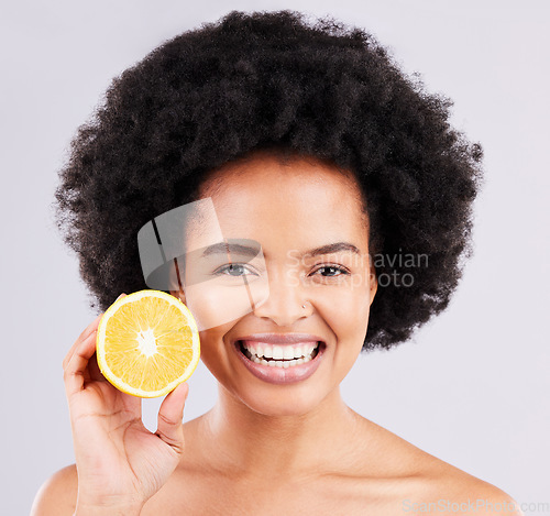 Image of Portrait, skincare and orange by black woman in studio for vitamin c, wellness or skin on white background. Face, fruit and girl model excited for citrus treatment, cosmetic or anti aging beauty