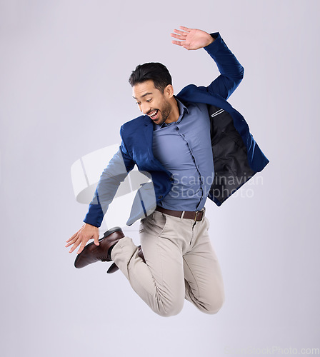 Image of Businessman, excited and jumping in studio with happy smile with winning expression on white background. Freedom, success and jump, Indian man with energy and motivation in celebration of winner deal