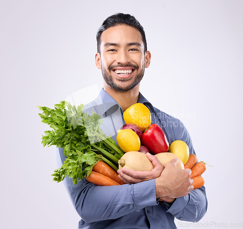 Image of Healthy, groceries and portrait of an Asian man with vegetables isolated on a white background in a studio. Smile, holding and a Japanese male with food for a diet, vegan lifestyle and nutrition