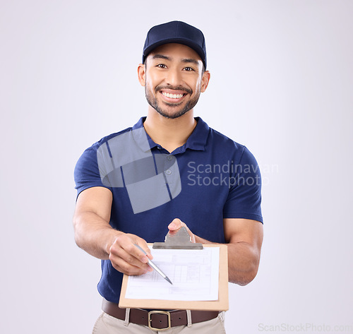 Image of Delivery, signature and portrait of asian man in studio for shipping, courier or supplier. Logistics, writing and clipboard with male on gray background for ecommerce, postage or package distribution