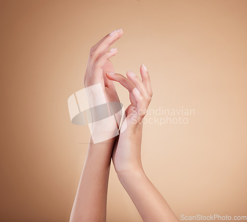 Image of Hands, manicure and natural nails beauty of female model with cosmetic care, skincare or self care isolated in brown studio background. Beauty salon, palm and polish for bodycare and healthy skin