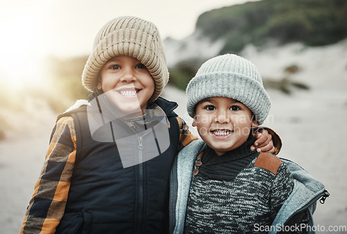 Image of Portrait, children and brothers on the beach together during summer on holiday or vacation in nature. Kids, sand and travel with a young boy friends bonding outdoor on the coast during the day