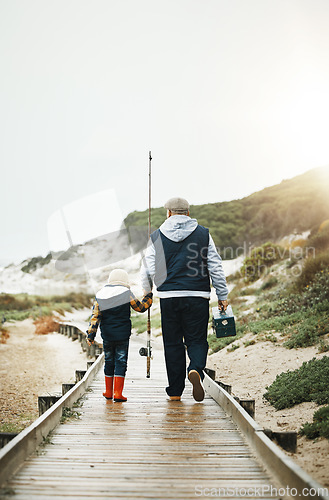 Image of Fishing, child and grandfather walking on beach pier with tools from back, bonding time on weekend with mockup. Nature, family and old man with boy holding hands and learning catch fish in Greece.