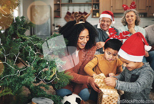 Image of Love, Christmas and family opening presents, festive and happiness with quality time, joy and bonding. Grandparents, mother and children with gifts, Xmas and loving together with smile or celebration