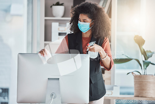 Image of Woman, covid and spray for cleaning computer with face mask, workplace safety and liquid for healthcare. Professional cleaner, desktop pc and clean to stop virus in office with bacteria risk at job