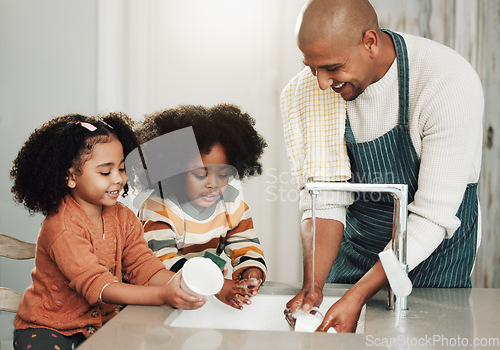 Image of Cleaning, learning and happy with black family in kitchen for bonding, hygiene and teaching. Smile, support and natural with father and children rinse dishes at home for sanitary, washing and chores
