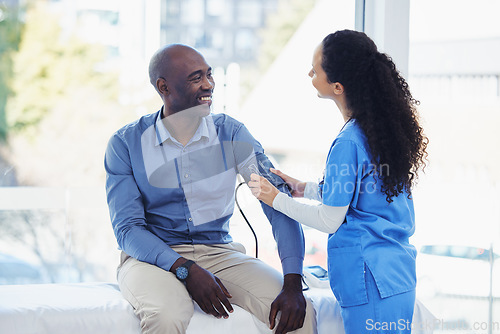 Image of Black man, doctor and blood pressure healthcare in hospital for health insurance consultation. Patient and professional nurse woman talking about hypertension, wellness and advice for healthy life
