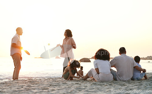 Image of Travel, game and family at the beach on a summer vacation, adventure or weekend trip in Australia. Sunset, fun and people playing sports on the sand by the ocean on seaside holiday together.