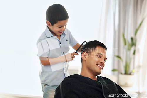 Image of Father, family and kid comb hair in home for grooming, cleaning and styling. Smile, hairdresser and happy boy or child combing man and dad for new look or hairstyle while bonding and playing in house