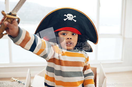 Image of Pirate, box and portrait of black child in living room for creative, playful and fantasy. Sailing, games and imagine with kid playing in cardboard boat at home for comedy, childhood and youth