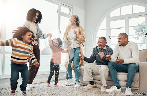 Image of Big family, children dancing and living room with parents, grandparents or love with holding hands in home. Girl kids, mom and dad with cheerful dance, smile or happiness in house together on holiday