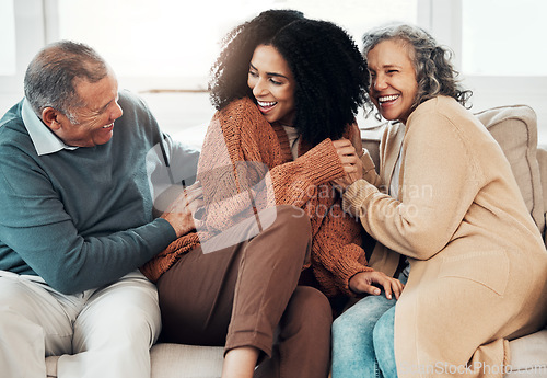 Image of Family, playful and a black woman at her parents home for a visit while bonding on a sofa in the living room together. Love, relax and a senior father tickling his daughter while having fun