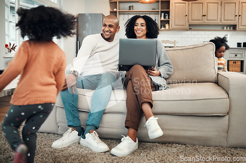 Image of Parents, relax and children playing in a home or house with mom and dad working on laptop and spending quality time together. Happy, playful and young couple or mother and father watching kids play