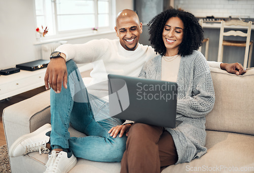 Image of Relax, happy and couple on a sofa with laptop in the living room of their modern house. Love, romantic and young man and woman browsing or scrolling on social media or internet with computer together