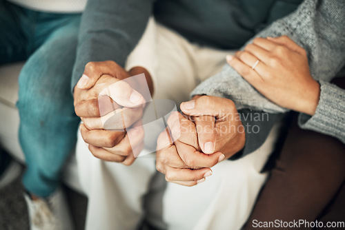 Image of Support, love and family holding hands on sofa for comforting embrace, prayer and trust together at home. Motivation, empathy and connected parents and adult children for care, compassion and praying