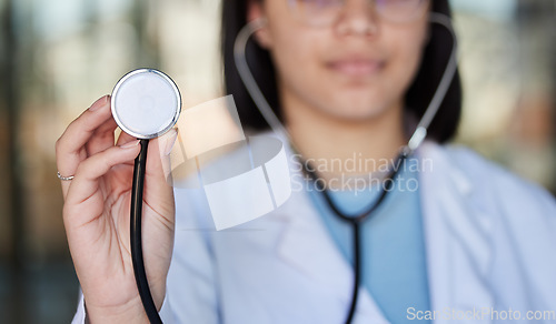 Image of Healthcare, stethoscope and hands of doctor listen in clinic for wellness, medical care and check up. Hospital, cardiology mockup and woman worker with tools for heart disease, exam and consulting