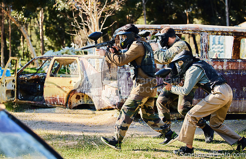 Image of Team, paintball and army moving on the attack in extreme adrenaline sport, battle or war in the nature outdoors. Group of people soldiers walking or aiming down sights in teamwork sports engagement