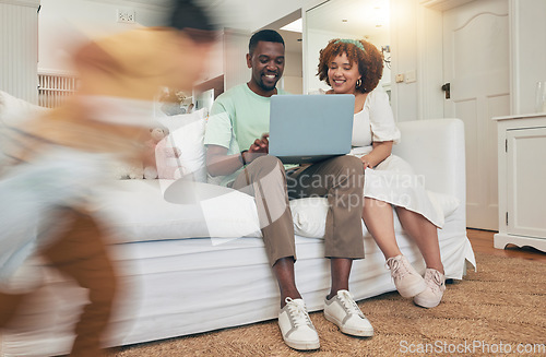 Image of Running, playing and family with a laptop in the living room for movie, streaming and show online. Interracial, happy and father and mother with a computer while children play with energy at home