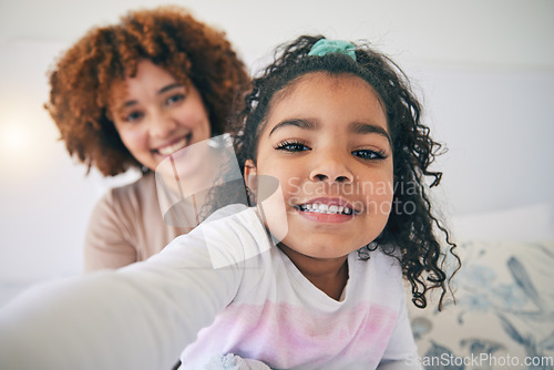 Image of Mother, bedroom and young girl selfie on a bed in the morning in a family home. House, smile portrait and happy mom with a child taking a picture for social media with mama love and care for her kid