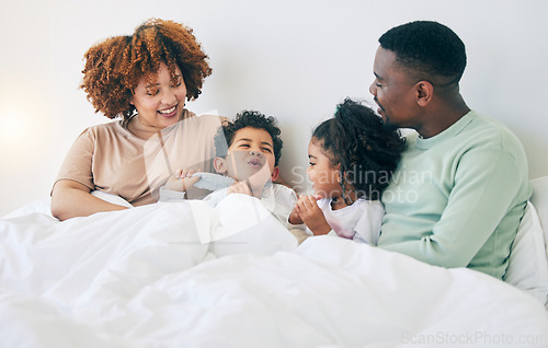 Image of Happy, love and parents with children in bed enjoy morning for bonding, quality time and relaxing. Black family, bedroom and mother, father and kids playing on holiday, weekend and vacation at home